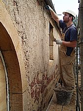 Shaun applying lime mortar to the south wall of the church